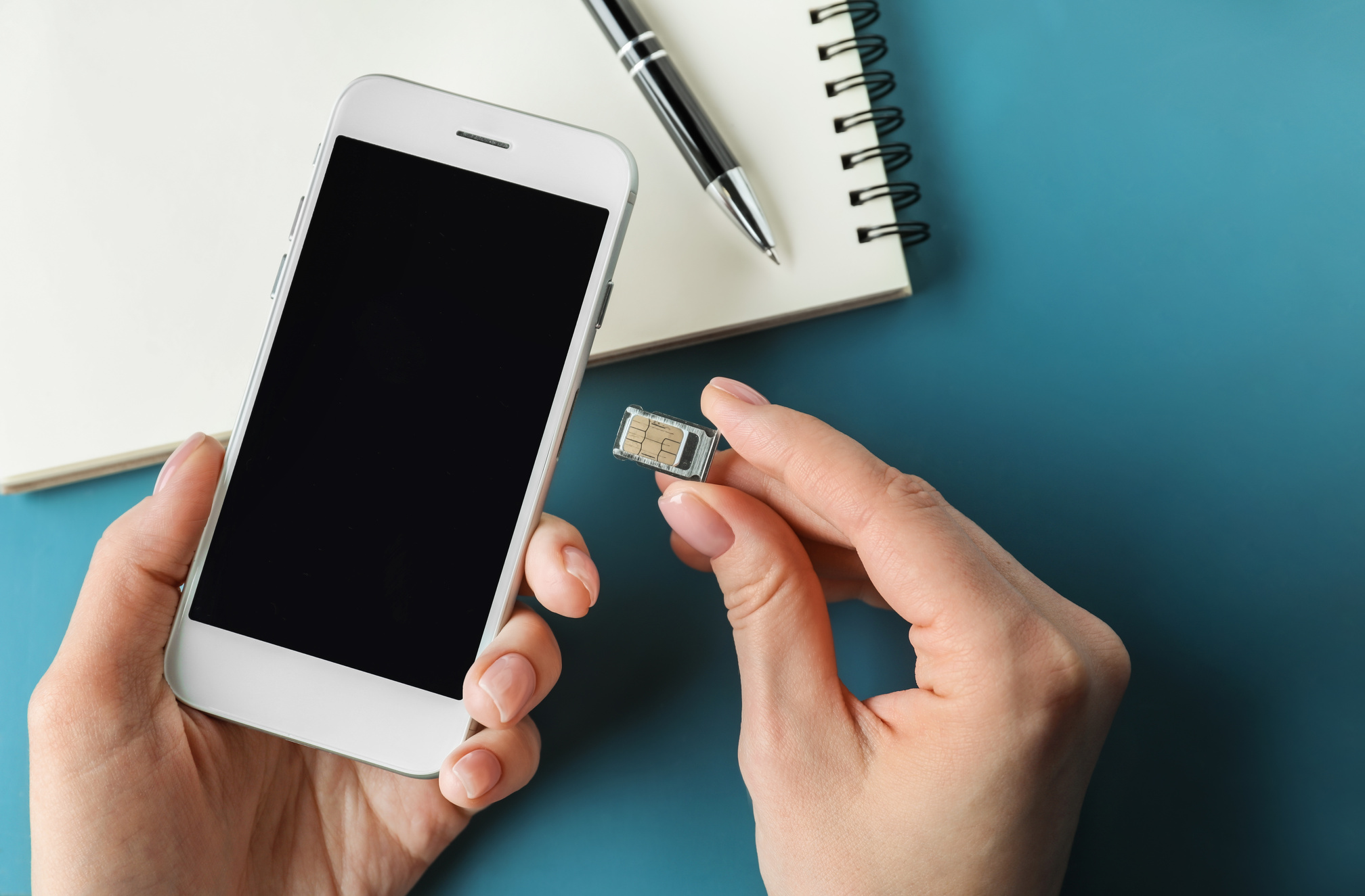 Woman Inserting Sim Card into Mobile Phone, Closeup