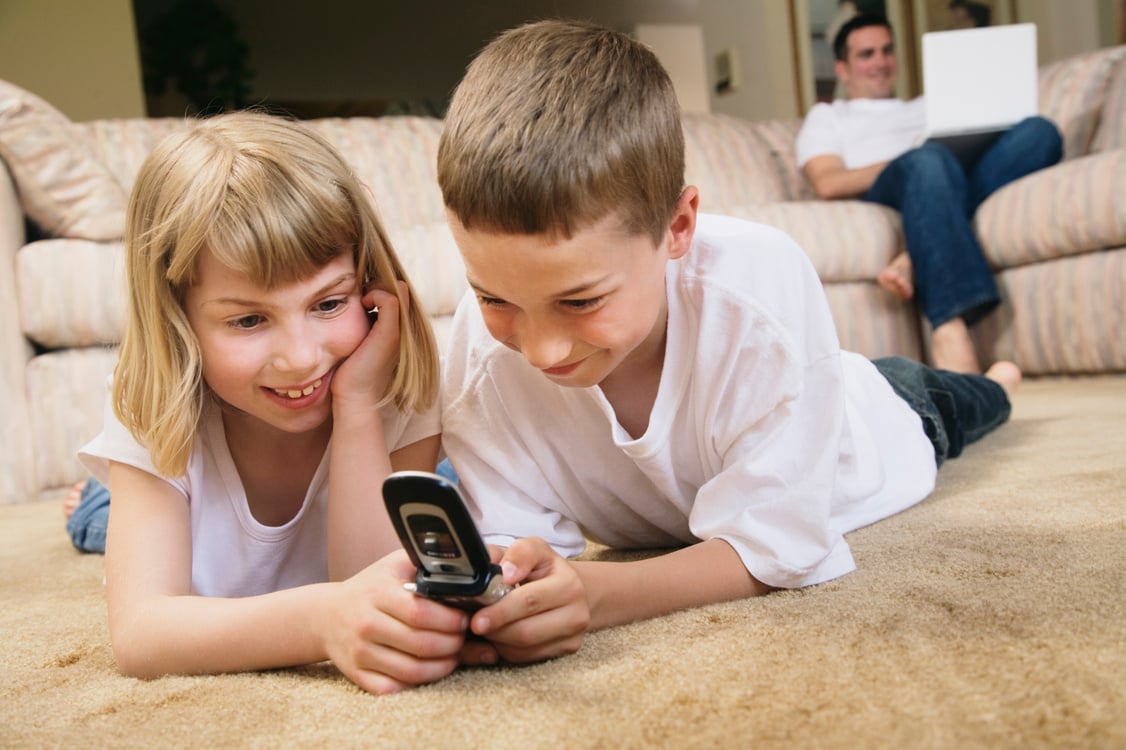 Children looking at cell phone